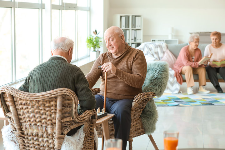 two men playing chess in respite care in nursing home
