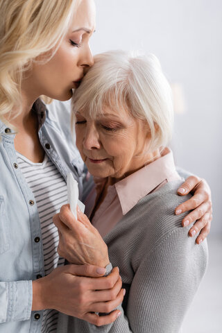adult mother and daughter embracing