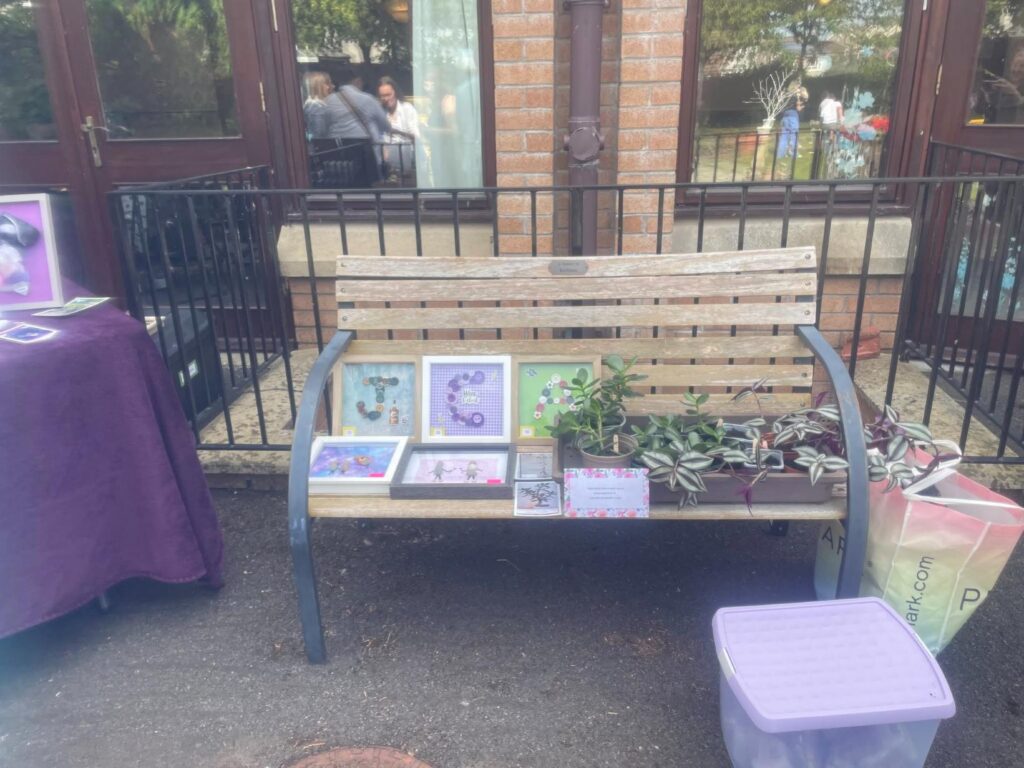 a wooden bench with arts and crafts on it